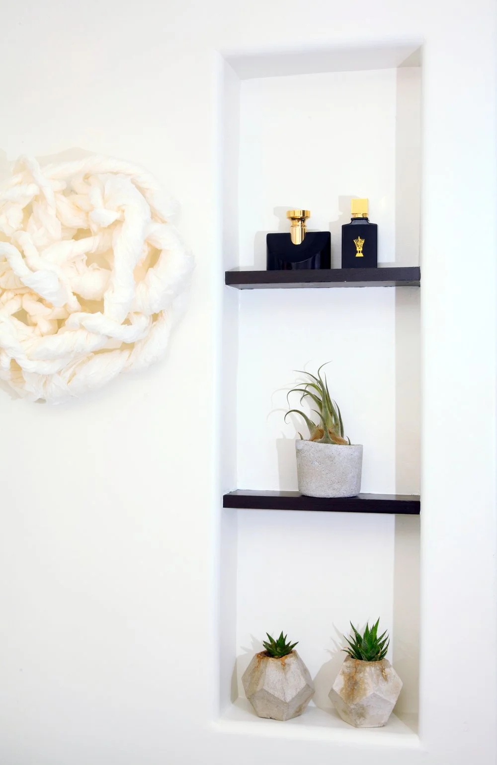 Photo by: Chas Metivier
A fiber sculpture by artist Renae Barnard hangs just to the left of a recessed wall niche that provides  a perfect space for integrating live plants.