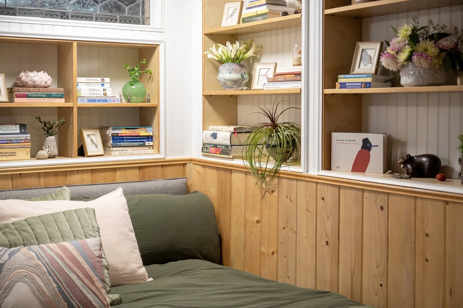 Photo by: Steven Dewall
Miniature paintings of a Ruby-crowned Kinglet, Hermit Thrush, California Quail, and Scaly Breasted Munia by artist Vivienne Edwards decorate the bookshelves throughout the space.