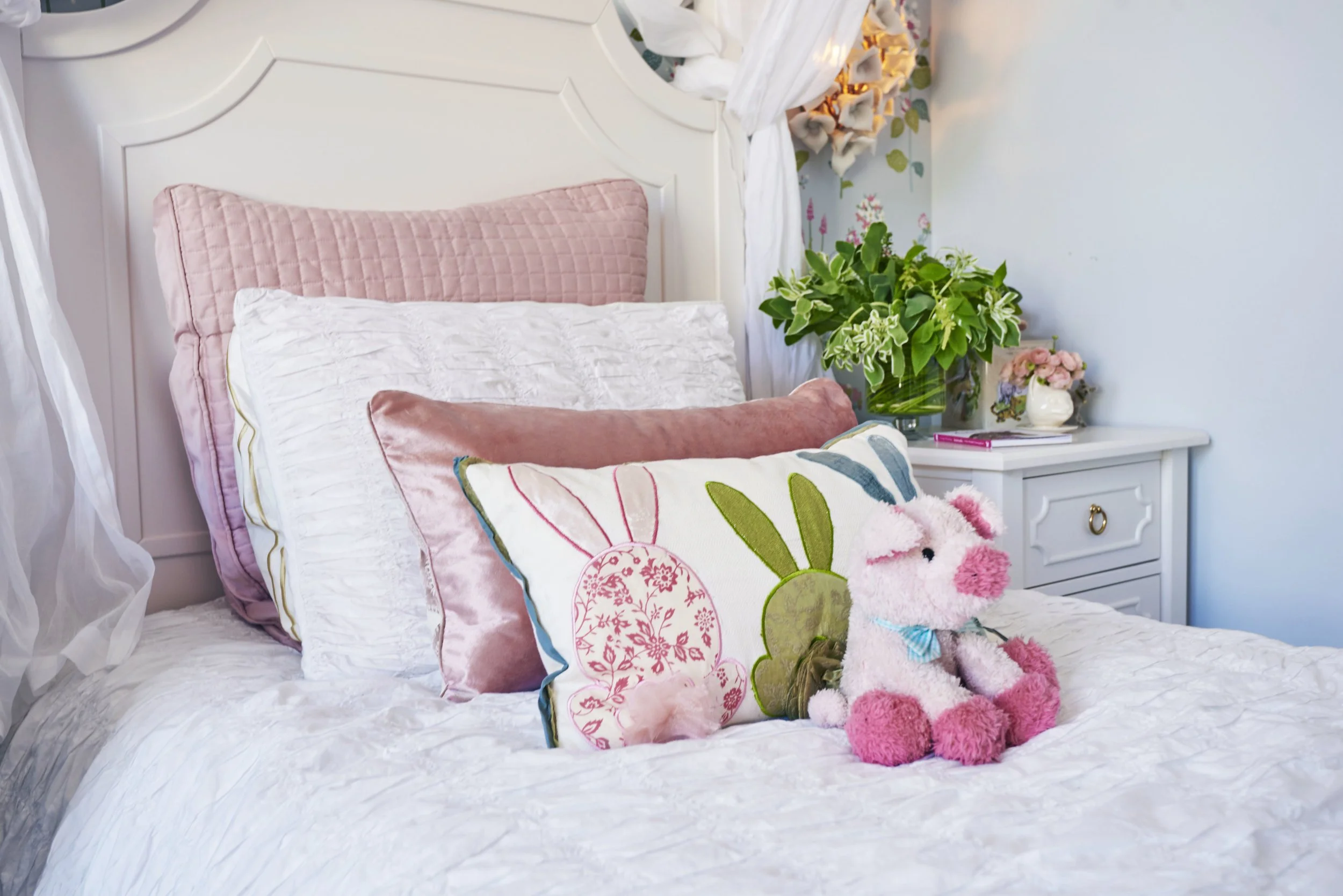 Photo by: Steven Dewall
Antique white furnishings and bedding are the perfect pairing with a host of pink, blue and green accents. 
