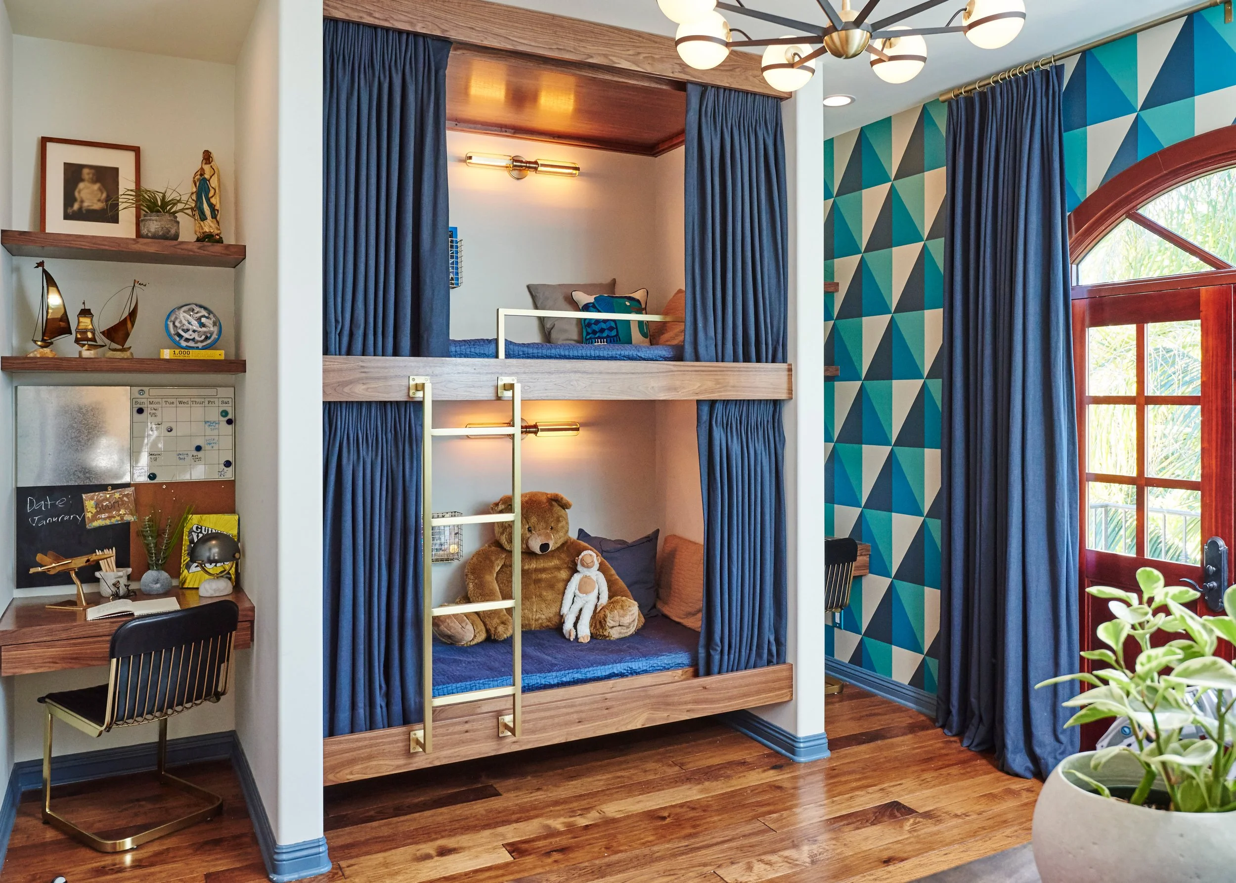 Photo by: Steven Dewall
Very possibly the best kid's bedroom ever!  In a color scheme of navy, teal, walnut, and antique gold, this space is both sophisticated and fun.