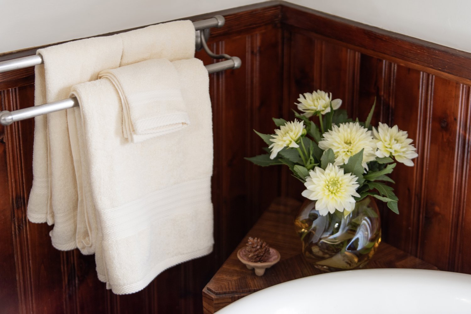 Photo by: Steven Dewall
The stained wood wainscot throughout this bathroom harmonizes with the natural wood details throughout this home.