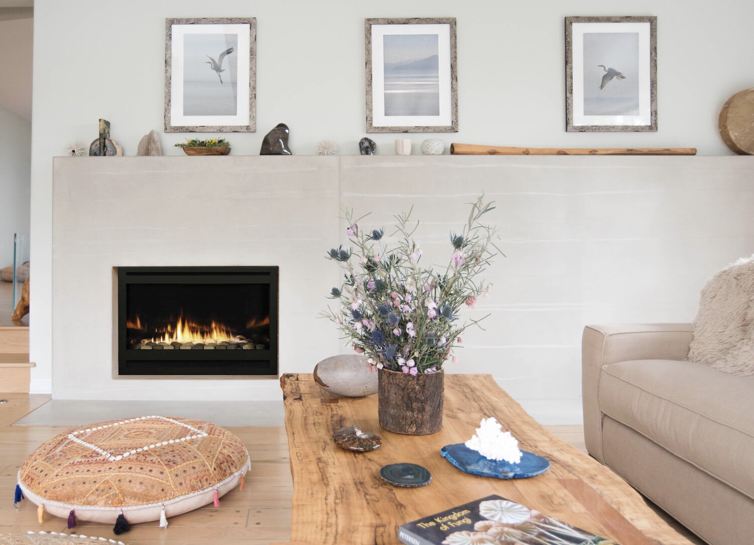 Photo by: Renae Barnard
A custom concrete fireplace was designed by Sarah Barnard and displays specimens from the homeowner's collection of minerals. 