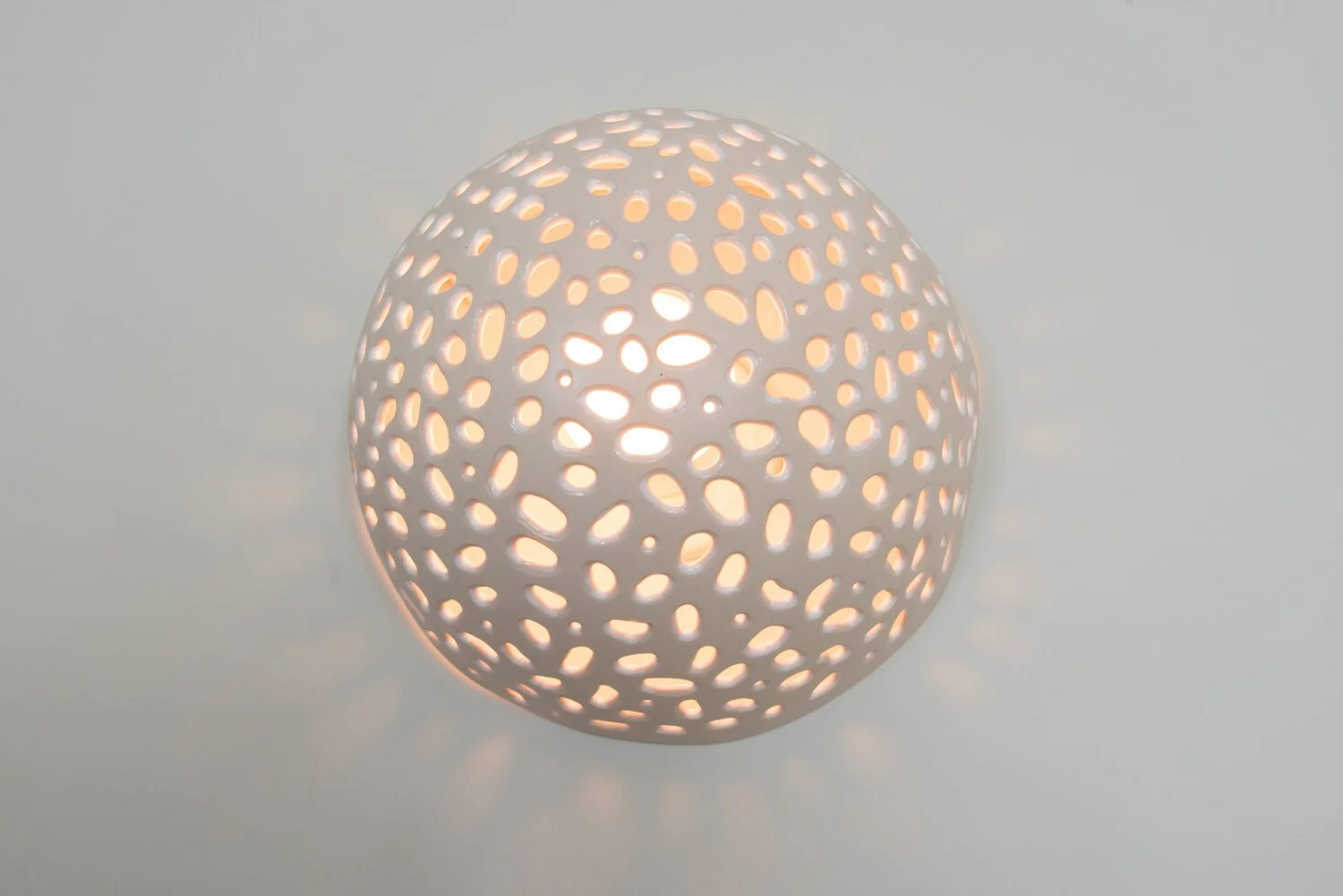 Photo by: Steven Dewall
Continuing to embrace the soft orbs in the designing of dining wall sconces, Sarah Barnard worked closely with a local artisan to realize her vision.