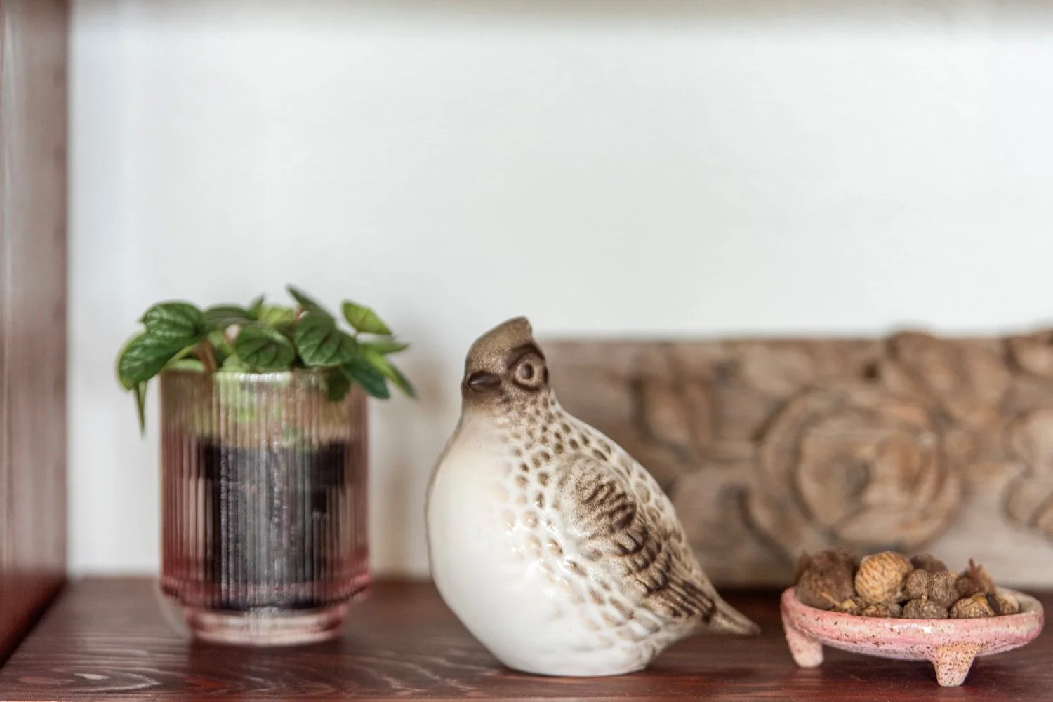 Photo by: Steven Dewall
A vintage mid-century modern ceramic quail sits next to a collection of acorns housed in a ceramic vessel.