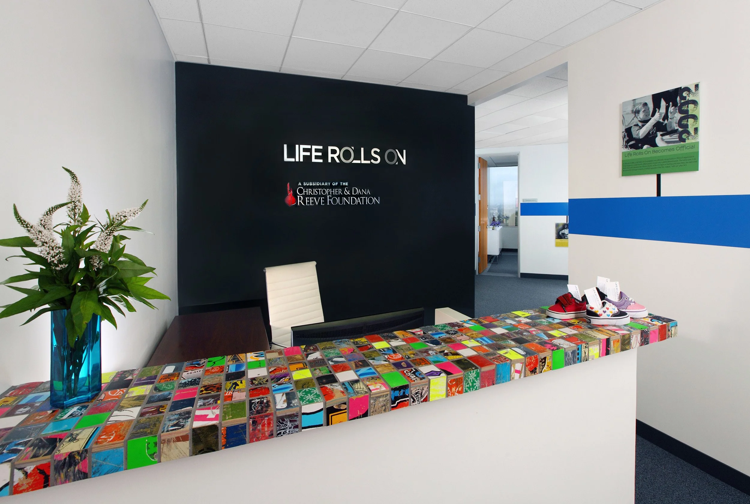 Photo by: Chas Metivier
Custom tile for the reception counter and conference room column was made by Art of Board using discarded skate board decks.