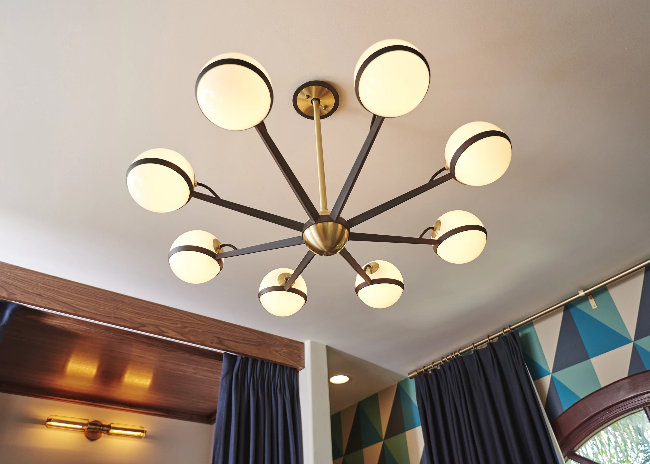 Photo by: Steven Dewall
The vintage inspired brass and black chandelier makes the room glow with warm diffuse light. 