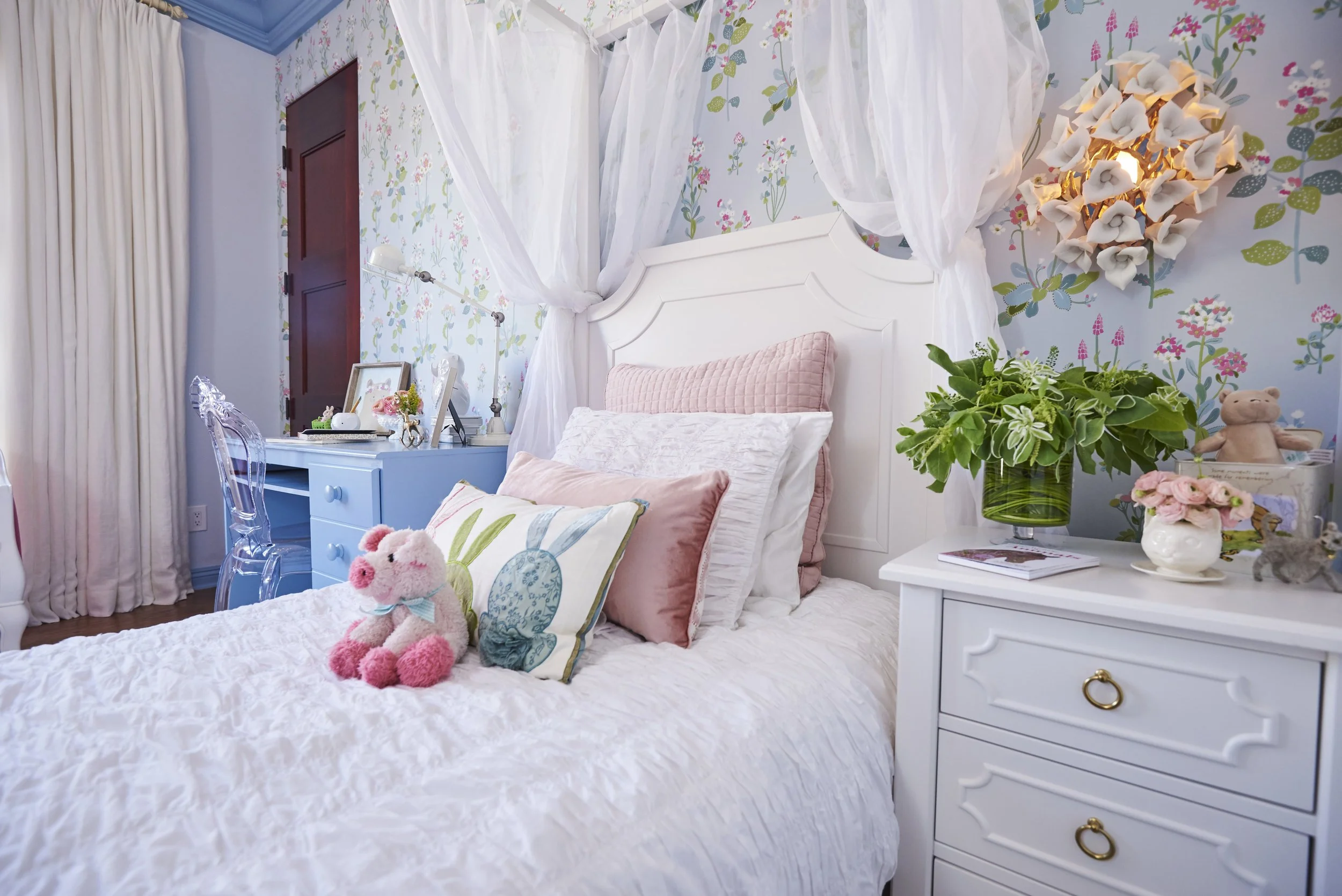 Photo by: Steven Dewall
Sheer white drapery panels frame the four posters of the bed in this little girl's room. 