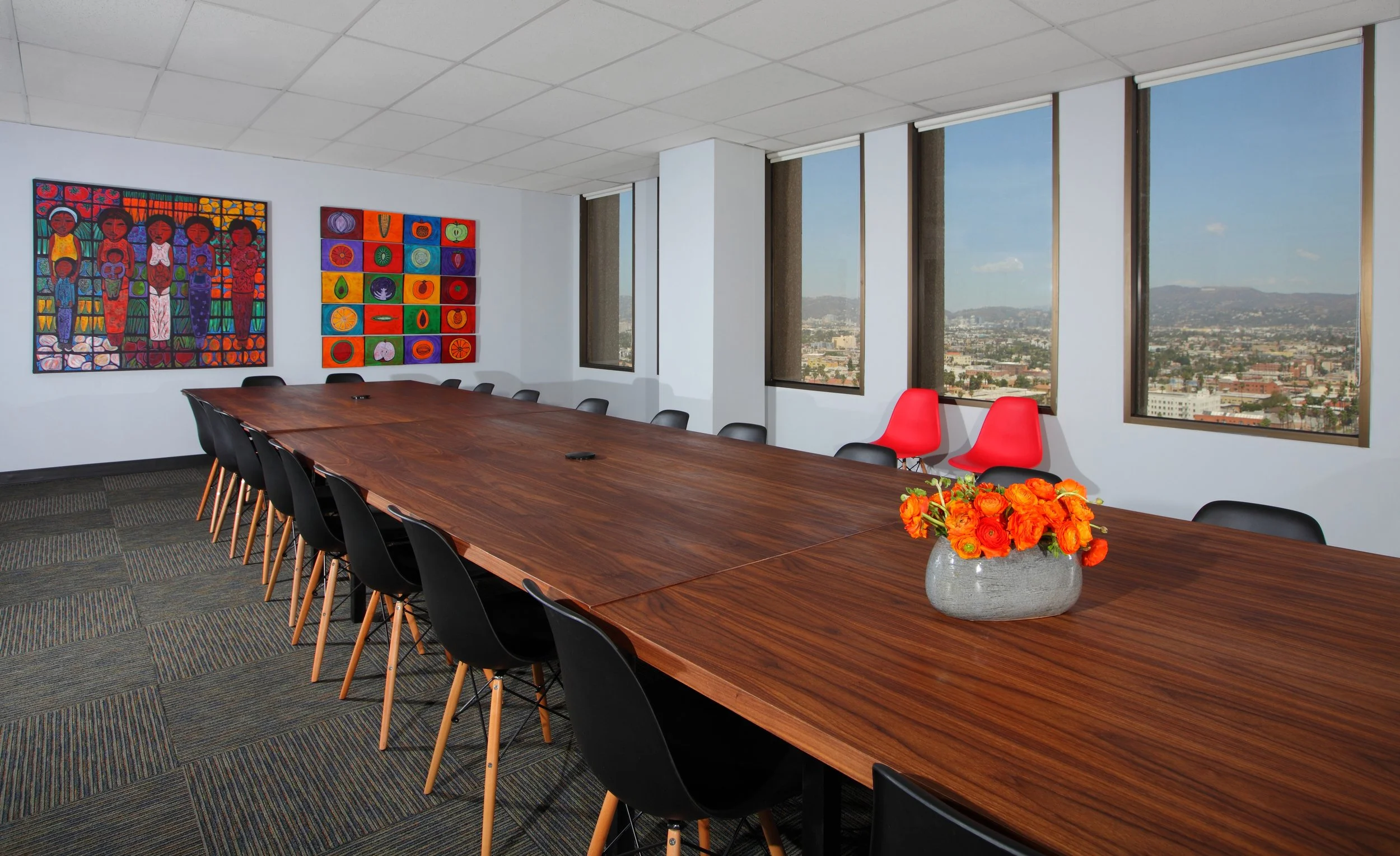 Photo by: Chas Metivier
A powerful diptych is formed by pieces entitled Nutrition and Soul of Food by Jose Ramirez.  These artworks highlight a custom walnut-veneered plywood conference table.