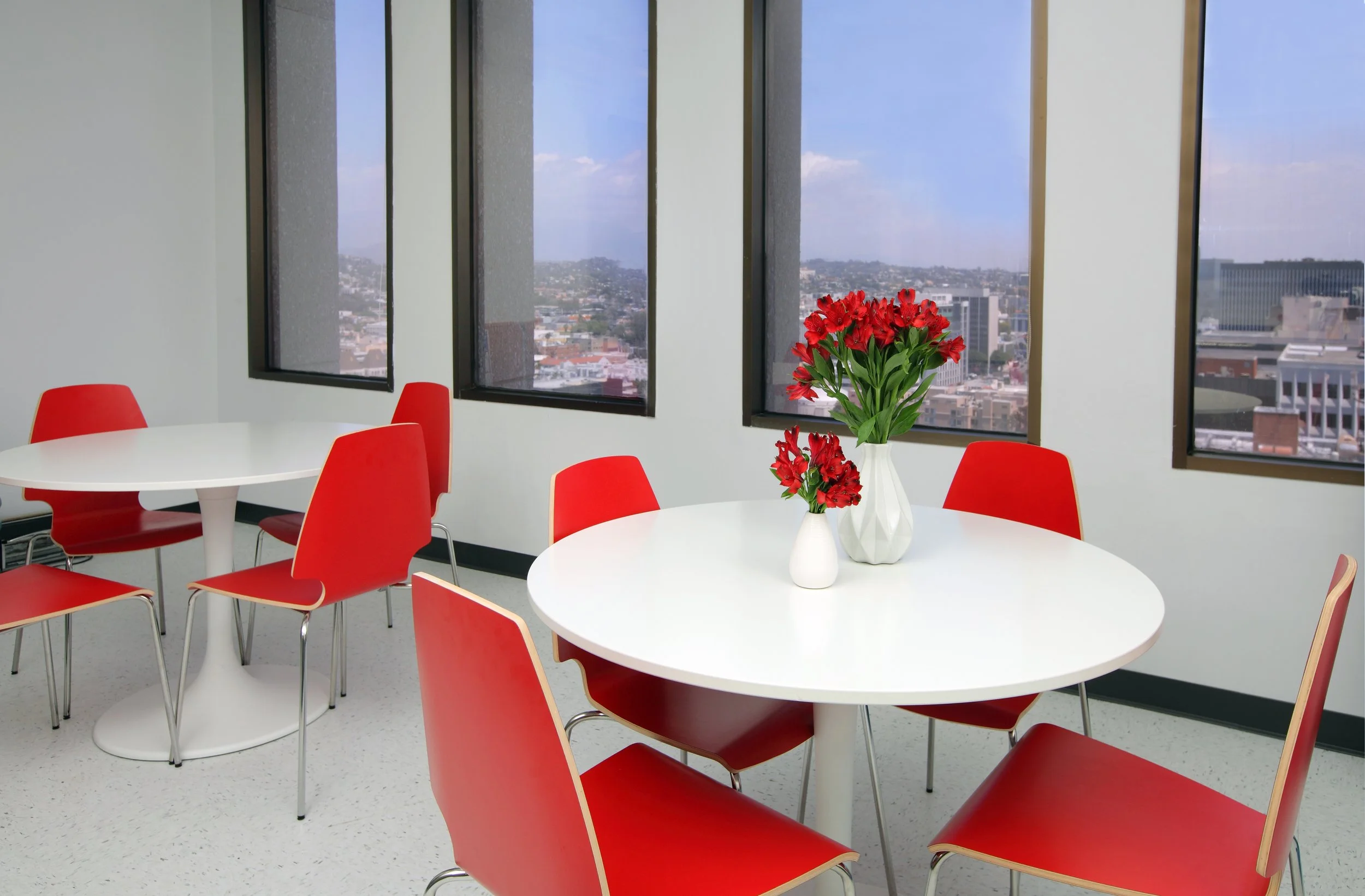 Photo by: Chas Metivier
Pops of red in the staff break room maximize a tight budget with a cheerful energetic aethetic. 