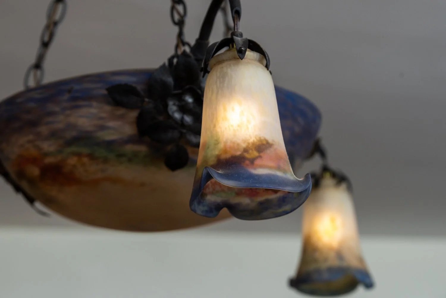 Photo by: Steven Dewall
The blue, cream, and amber glass of this Art Deco chandelier by the Muller Brothers of Luneville, France, emulates the feeling of a beautiful sunset.