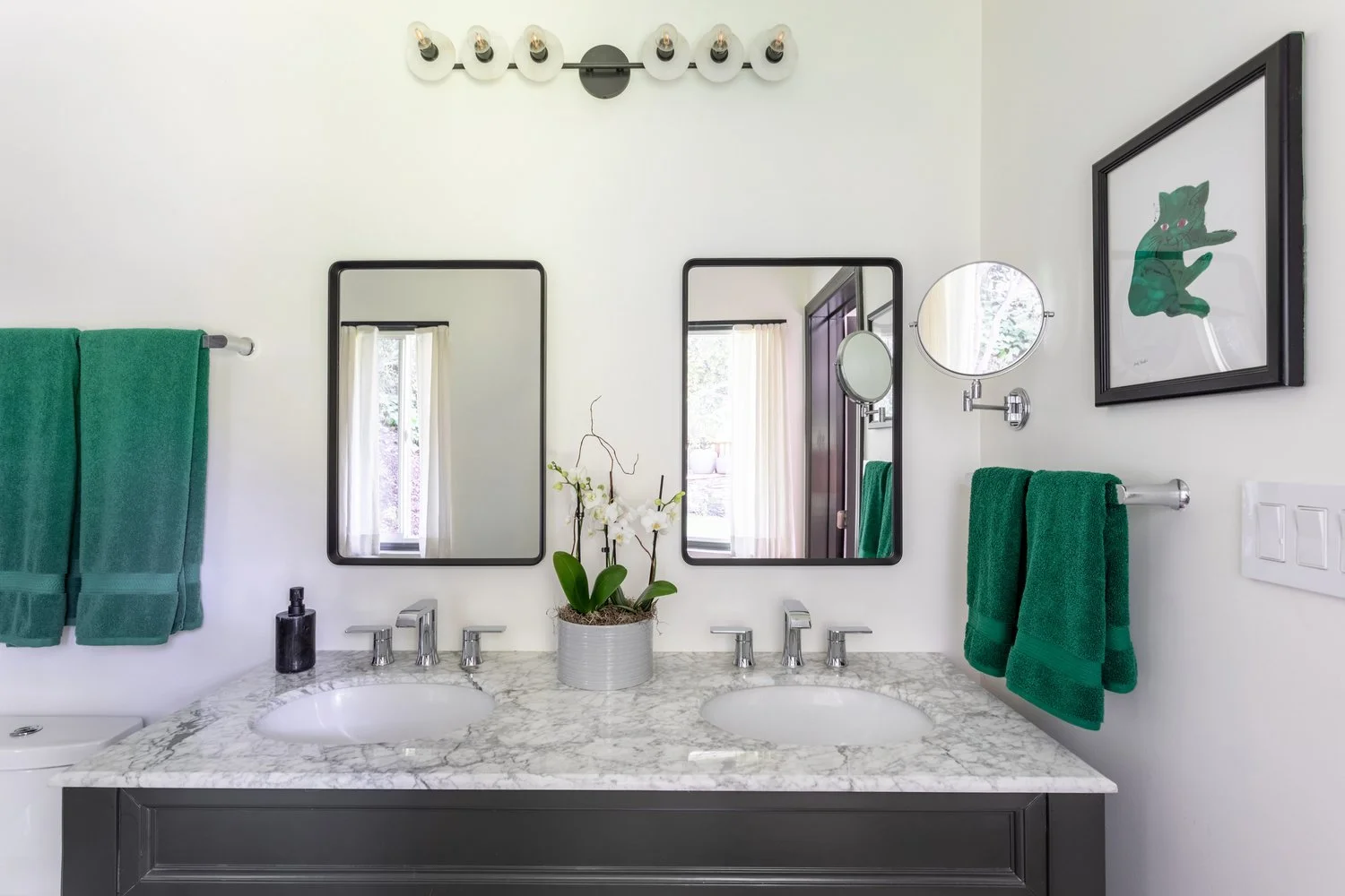Photo by: Ace Misiunas
The existing vanity was repurposed by painting it charcoal gray and installing new artisan-made hardware. The pewter finish of the leaf-shaped hardware creates a subtle nature reference.