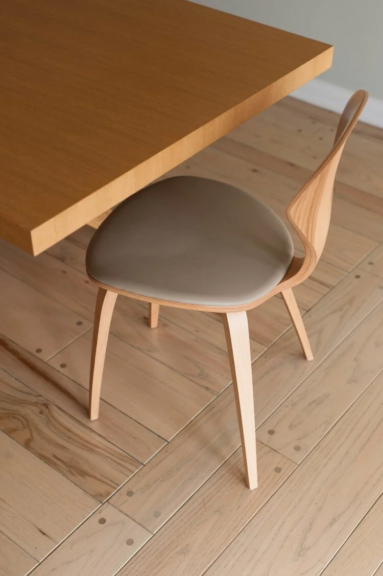 Photo by: Steven Dewall
Natural dining chairs by the Cherner Chair Company have a slim silhouette.