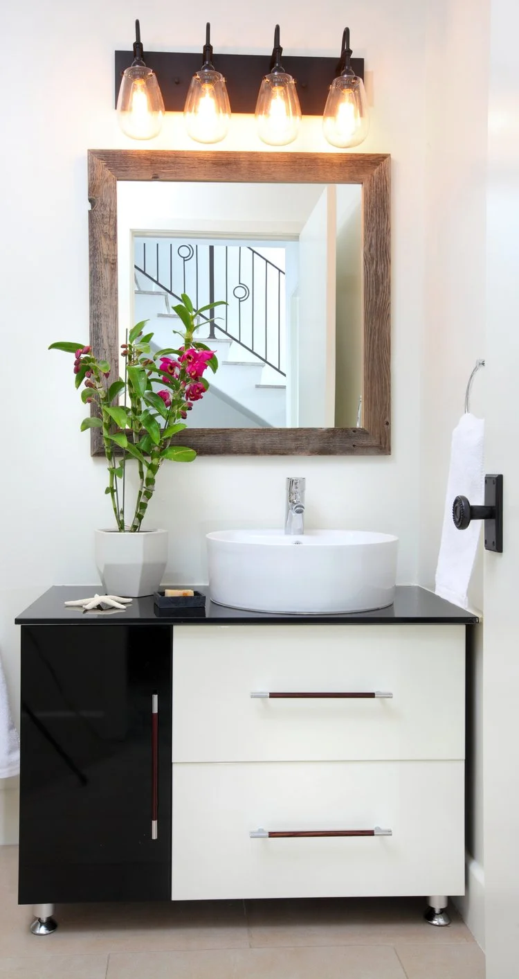 Photo by: Chas Metivier
Mid-century Modern meets rustic farmhouse chic in this elegant guest bathroom.