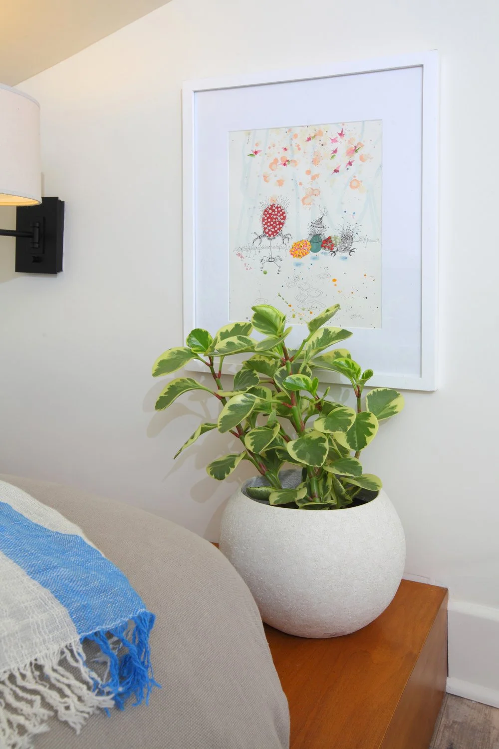 Photo by: Chas Metivier
Artwork by Karrie Ross and an adjustable swing arm wall sconce frame the sleeping nook.