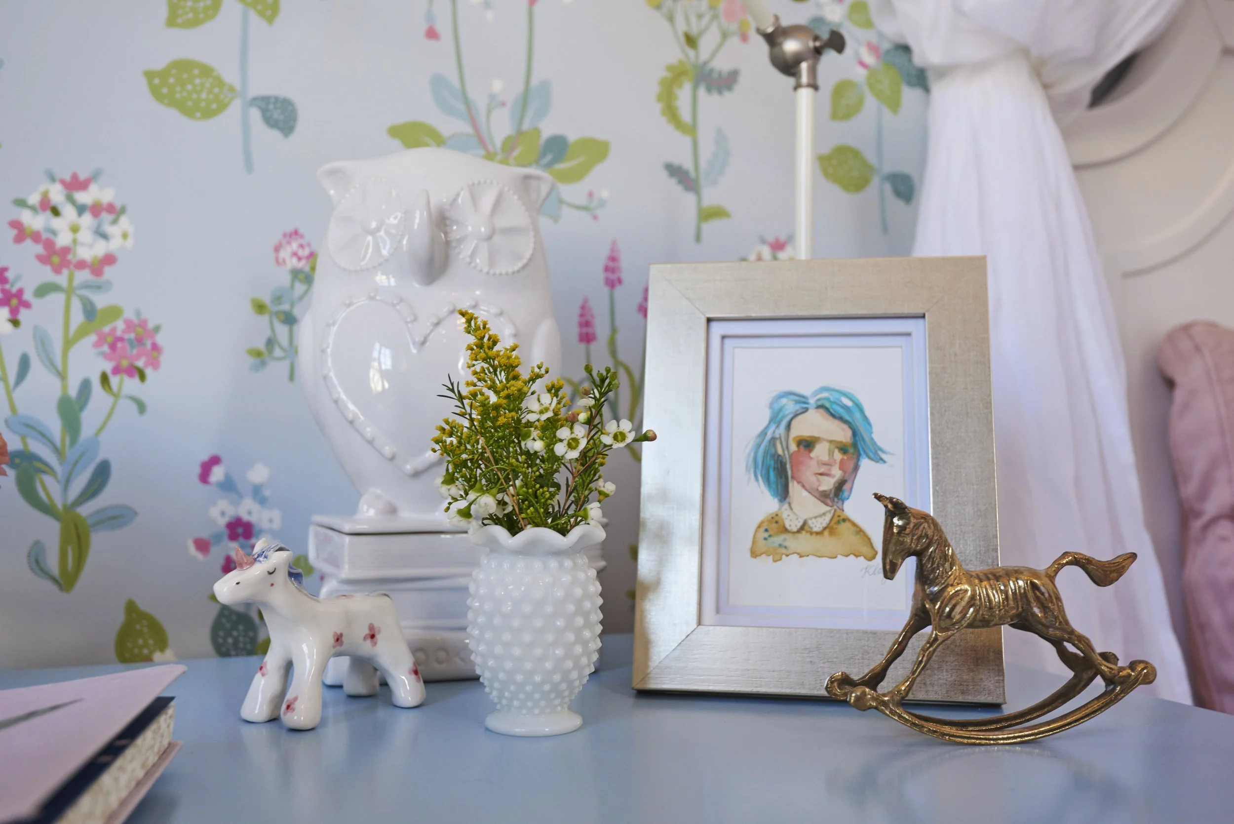 Photo by: Steven Dewall
A vintage brass rocking horse from the 1960s sits among a collection of other delightful works of art, including a unicorn sculpture from an artist in Slovenia, and a watercolor by Klay Arsenault.