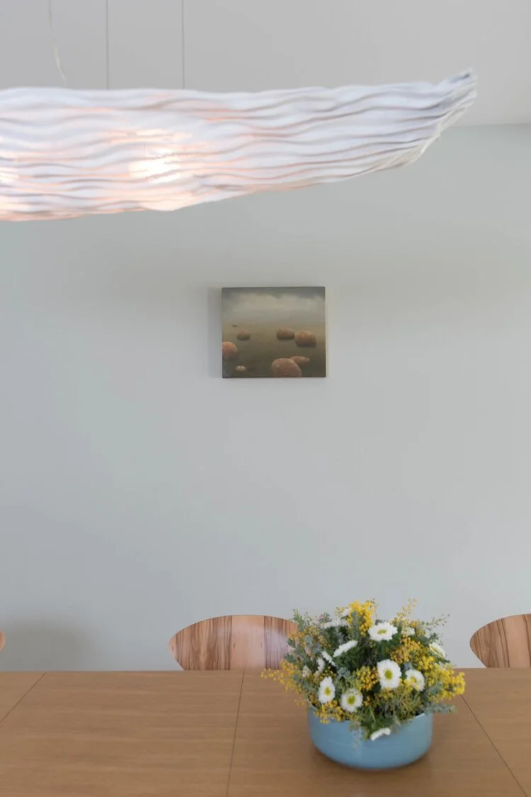 Photo by: Steven Dewall
The chandelier was selected because of it’s nearly weightless, gentle glow. Painting by Louise Lebourgeois.