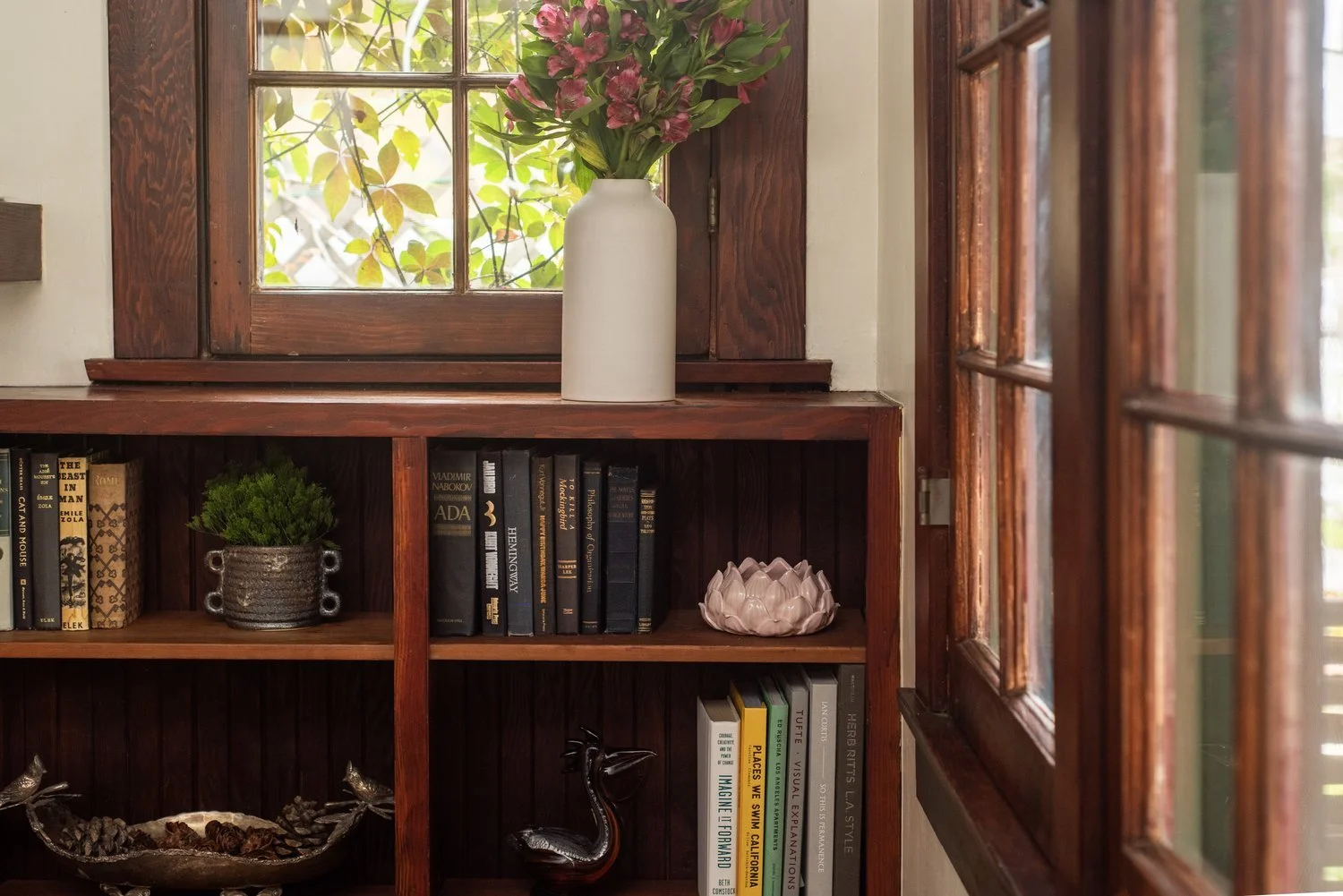 Photo by: Steven Dewall
Natural materials such as wood feature prominently throughout this home within the finished wood surfaces of the mantel, bookshelves, and window frames.