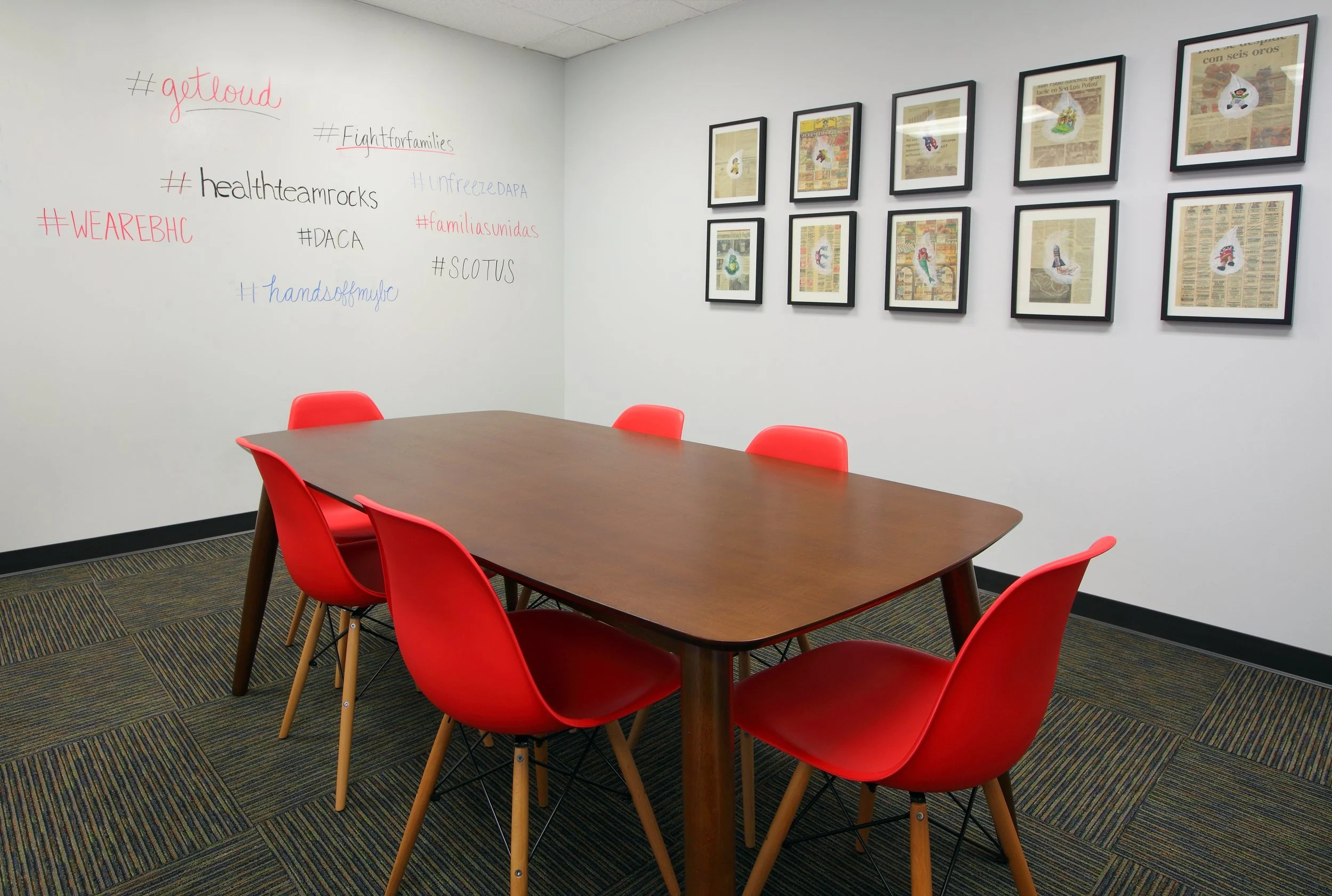 Photo by: Chas Metivier
This meeting room is used for focused staff meetings and brainstorming sessions. The dry erase white wall behind the table displays hashtags important to NILC's mission. 