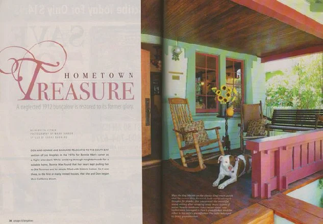 Interior porch with rocking chair, wooden bench, flower vase with sunflowers, and a dog sitting on the floor.