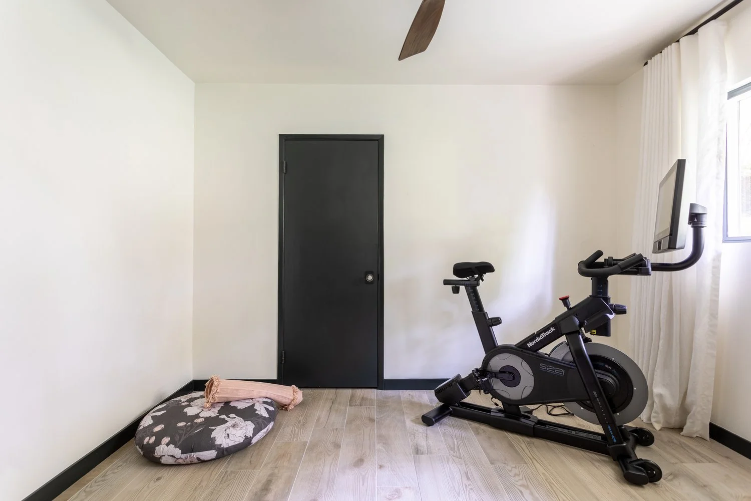 Photo by: Ace Misiunas
The custom meditation pillow is made from the Kale Tree Matilija Poppy textile in Midnight, bringing this beautiful California native wildflower indoors in a palette harmonious with the home gym door.