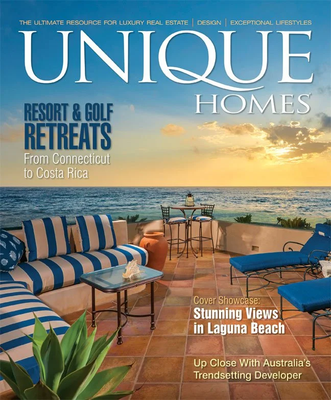 Cover of Unique Homes magazine featuring a balcony with outdoor furniture overlooking the ocean at sunset, with the headline 'Resort & Golf Retreats from Connecticut to Costa Rica' and highlights of scenic views at Laguna Beach and a trendy Australian developer.