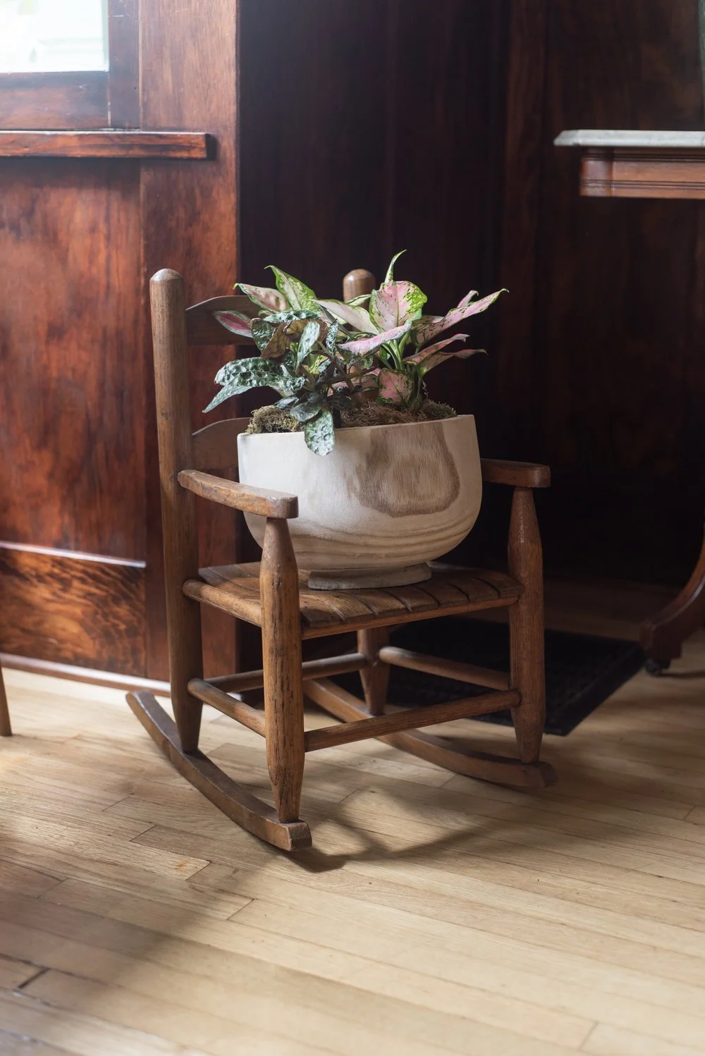Photo by: Steven Dewall
Many of the objects in this room have family history and personal meaning that infuse the space with memory and connection, such as this vintage rocking chair, a family heirloom repurposed as a plant stand.