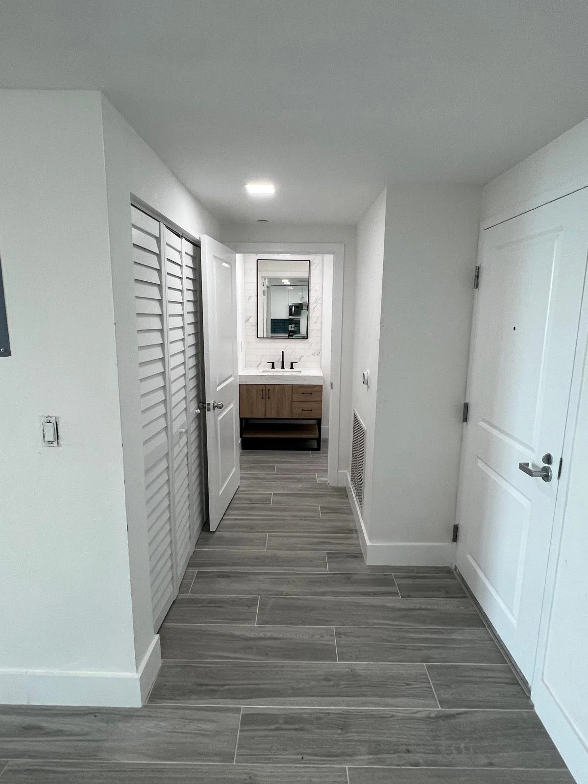 Brickell renovation Entrance with a powder room.