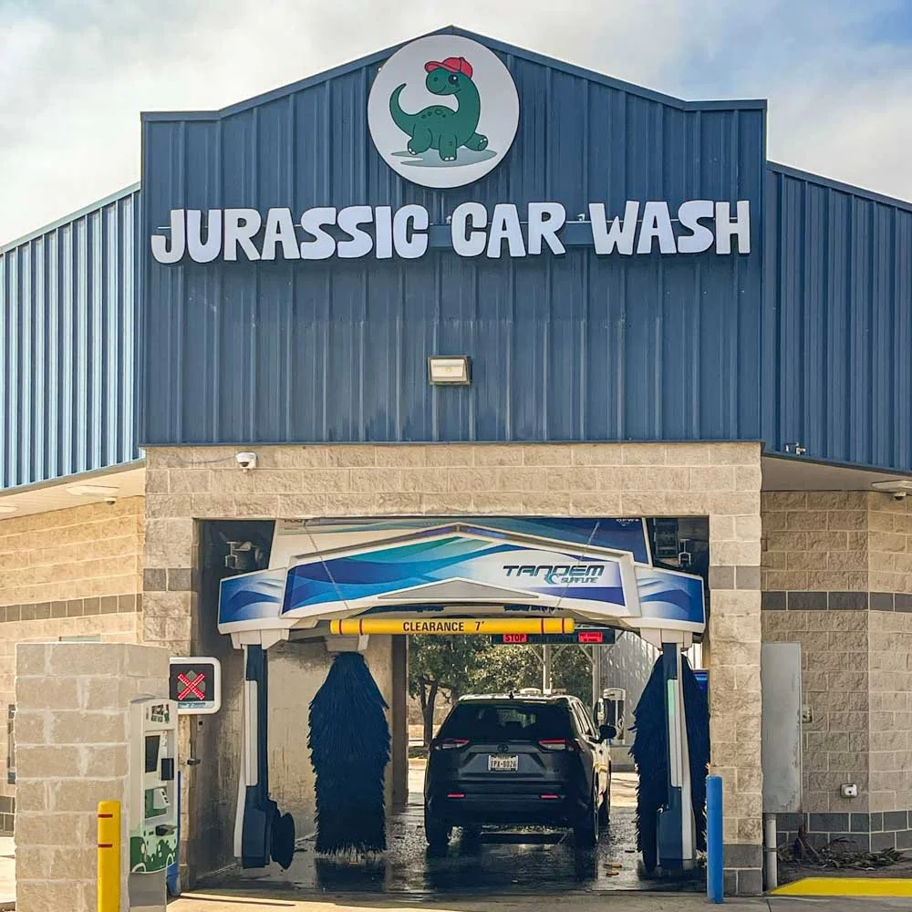 Jurassic Car Wash Marbach location in San Antonio, TX with in-bay automatic car wash entrance.