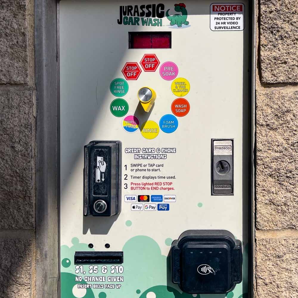 Self-serve wash control panel with pricing at Jurassic Car Wash Marbach location.