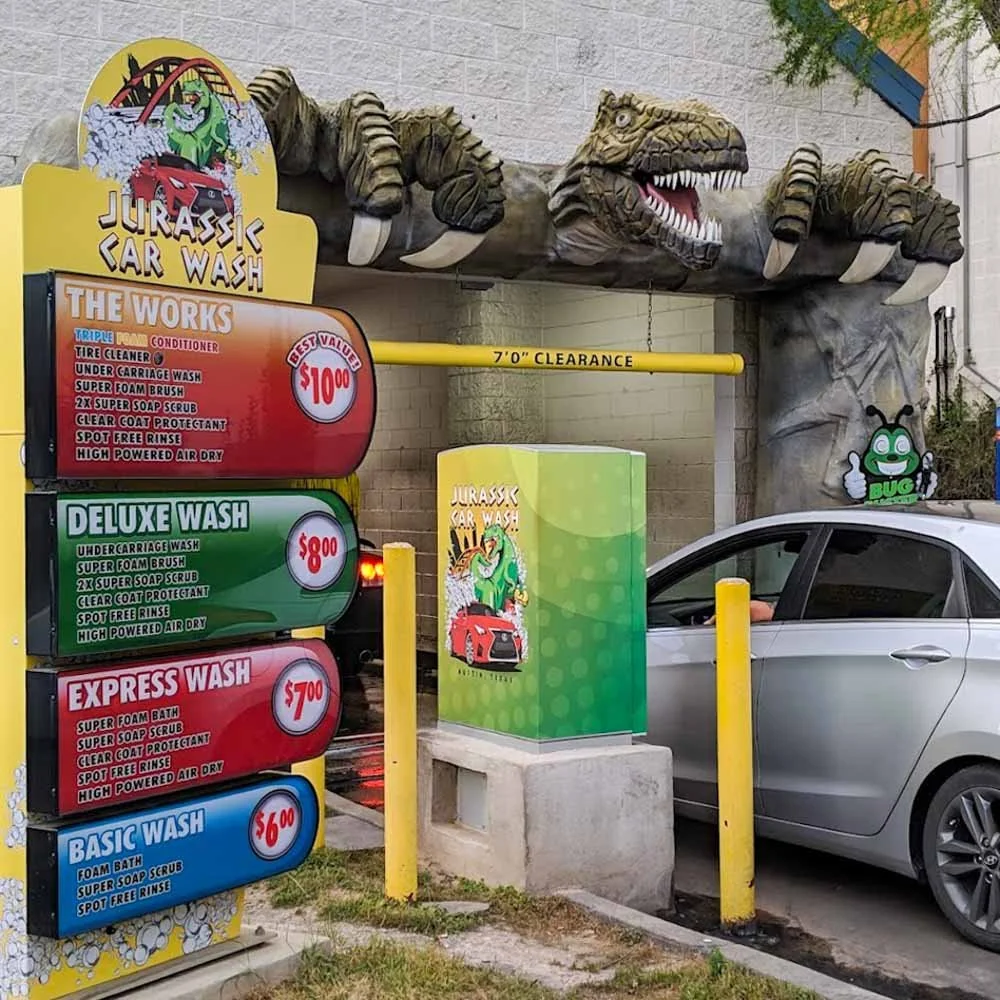 Jurassic Car Wash South Congress location entrance in Austin TX with automatic wash pricing and dinosaur tunnel