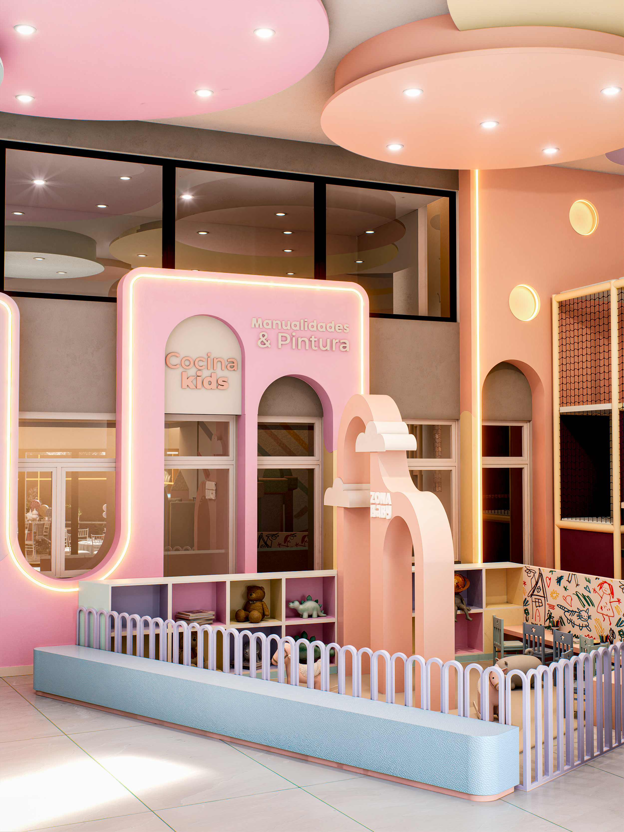 Interior de área de juegos para niños con paredes en tonos pastel, decoraciones de juguetes, y señalización que dice "Cocina kids" y "Manualidades & Pintura".