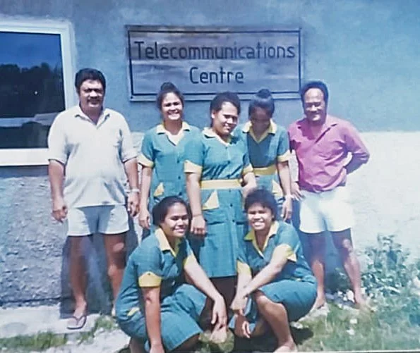 With co-workers at the Telecommunications Headquarters