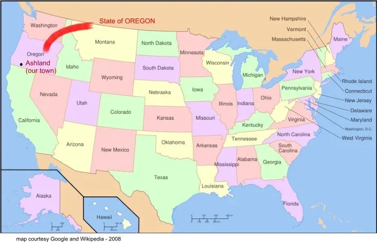 Map of the United States with state names. Oregon is marked with a red arrow and label, and Ashland is noted as a town in Oregon with a label. Other states are shown in different pastel colors.