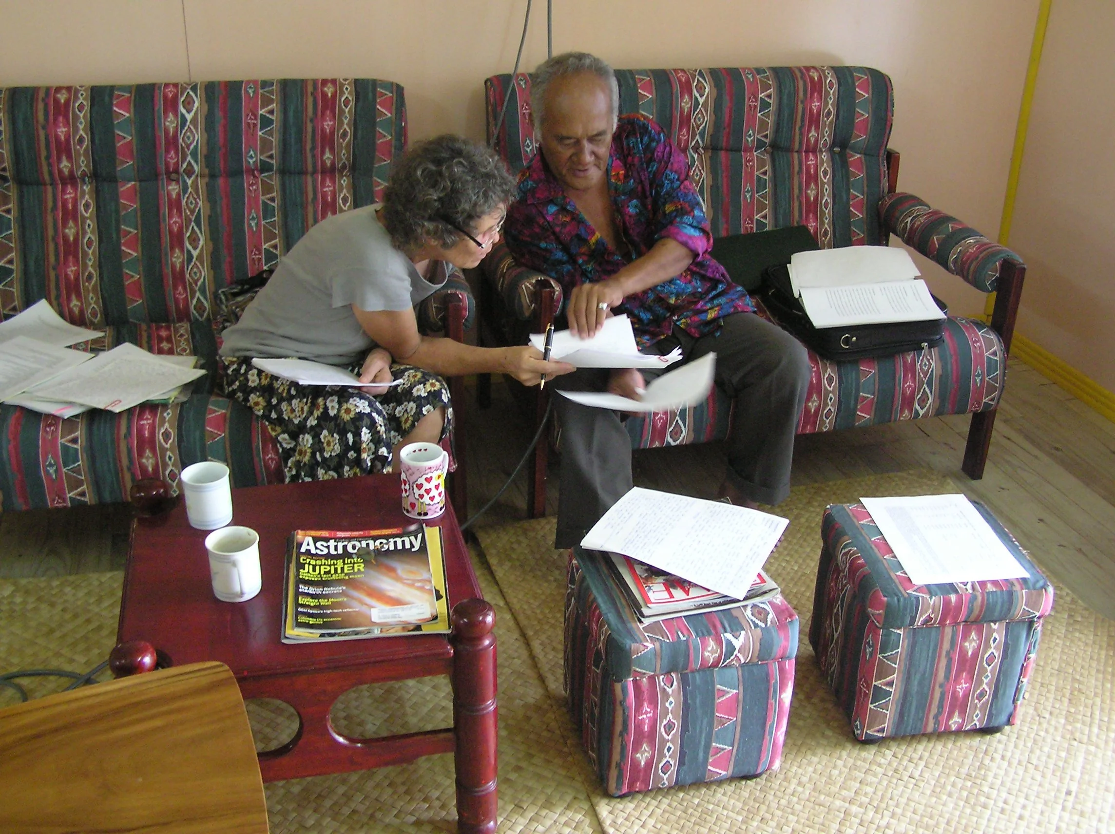 Tangisia and Anne sitting on a couch, discussing and editing the Fakavae, "Cultural Constitution".