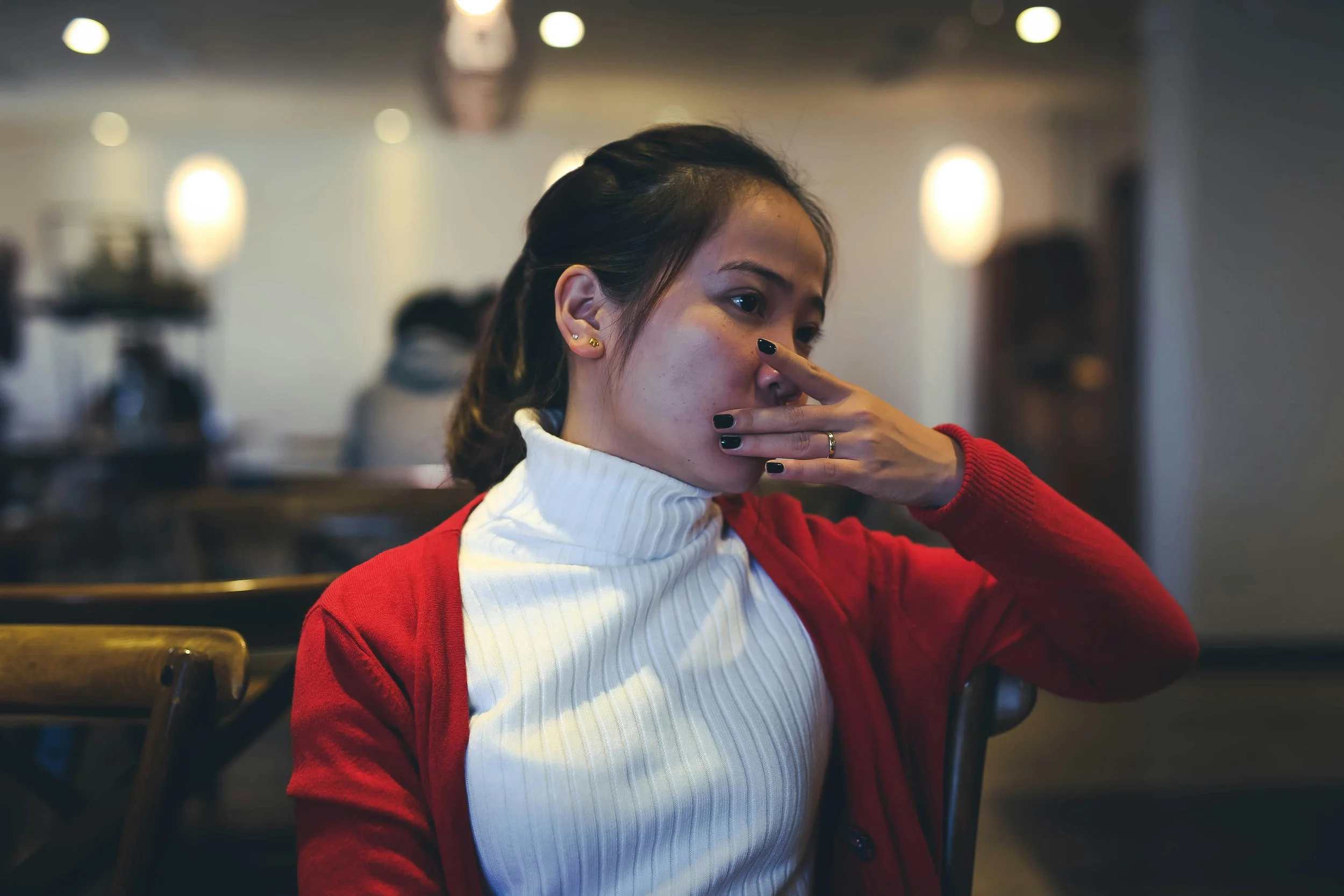 Person taking a breath and pausing to regulate before responding in a triggered conversation
