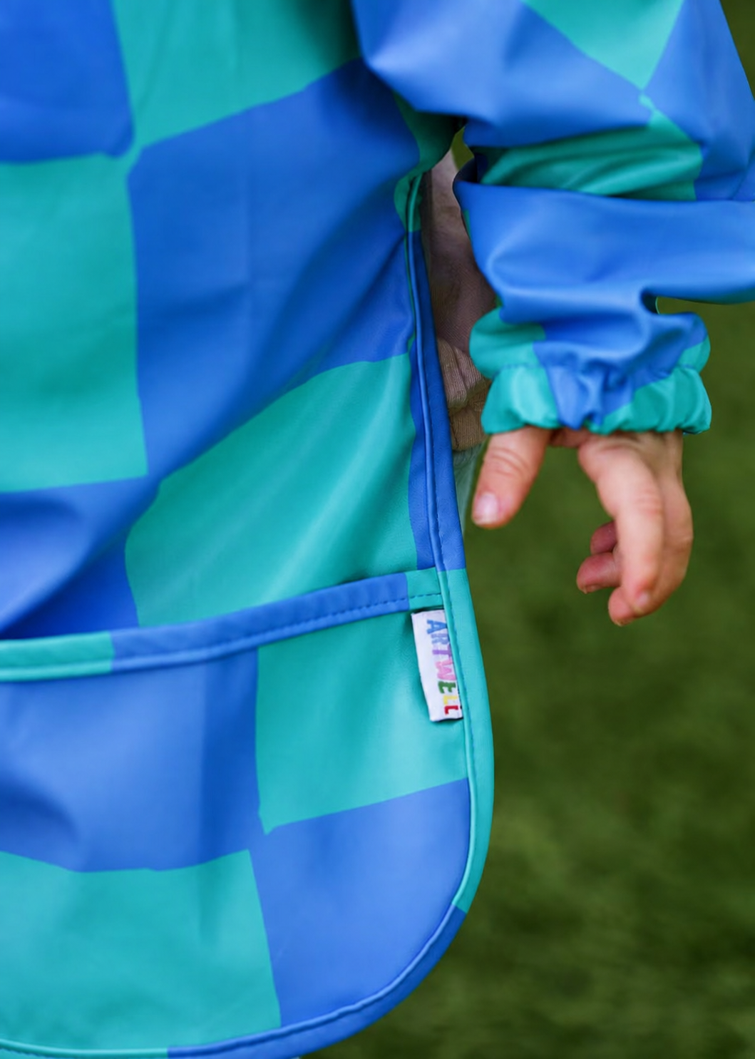ARTWELL toddler art smocks shown in Cerulean and Seafoam and Wisteria and Marigold.