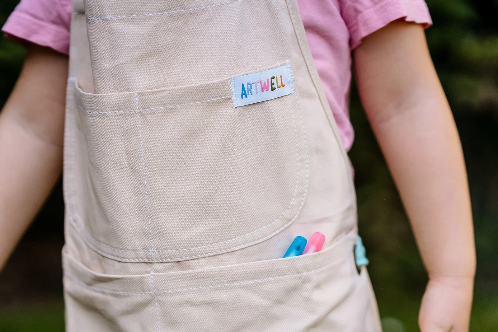 Colorful drawings made with the fabric markers included in the kids apron kit.