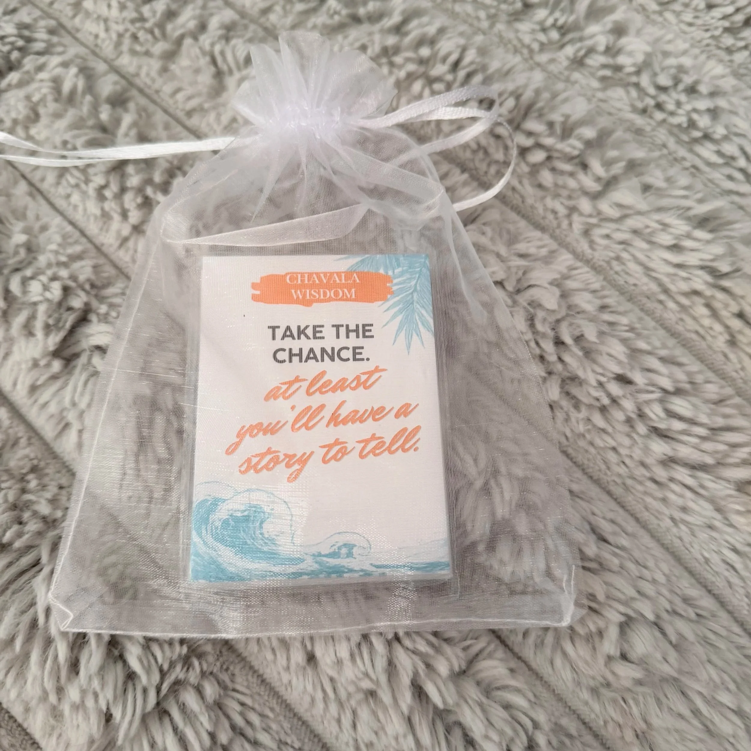 Chavala Wisdom affirmation cards inside a white organza drawstring bag.