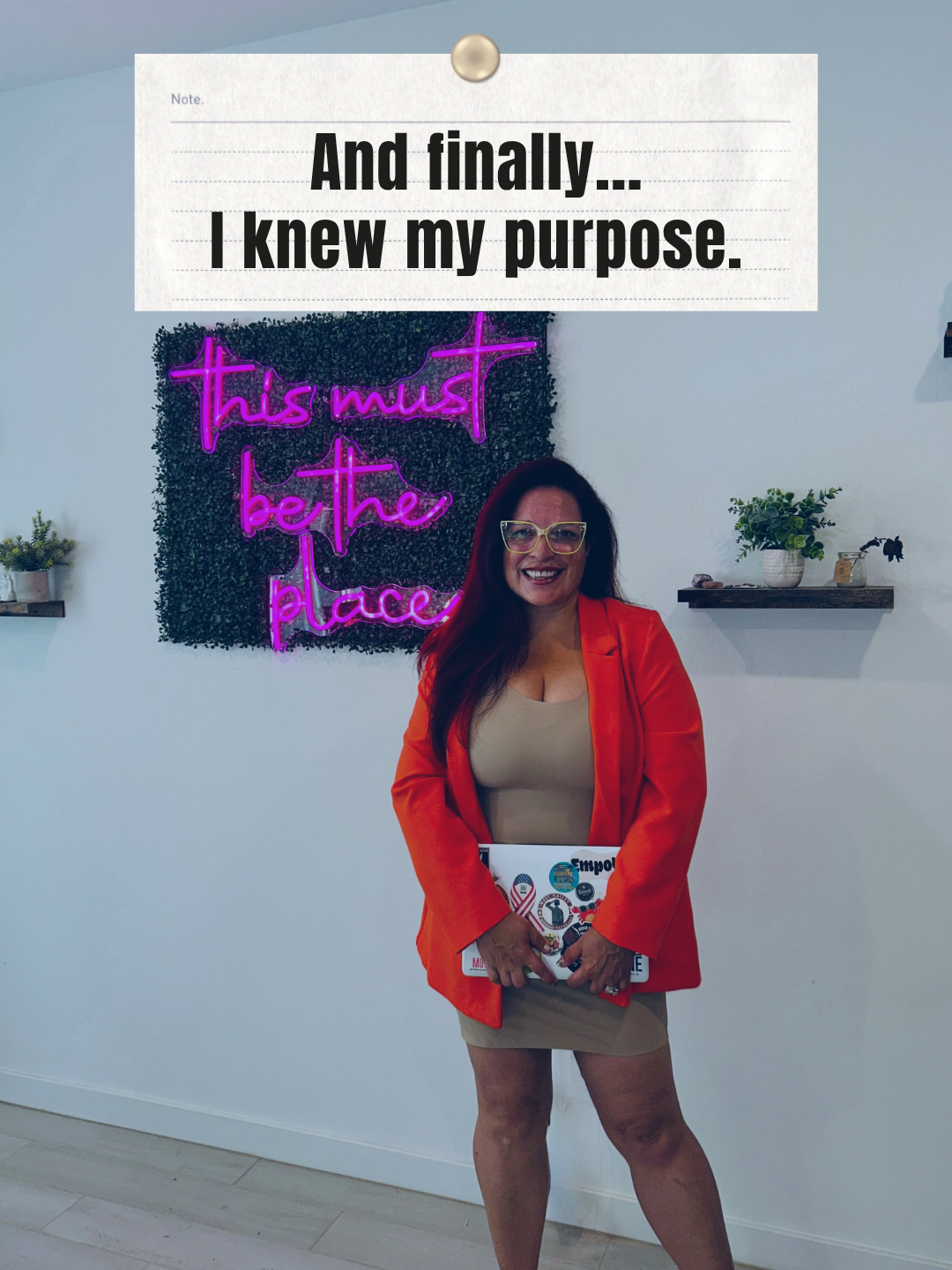 Woman standing in front of neon sign with text about finally knowing her purpose