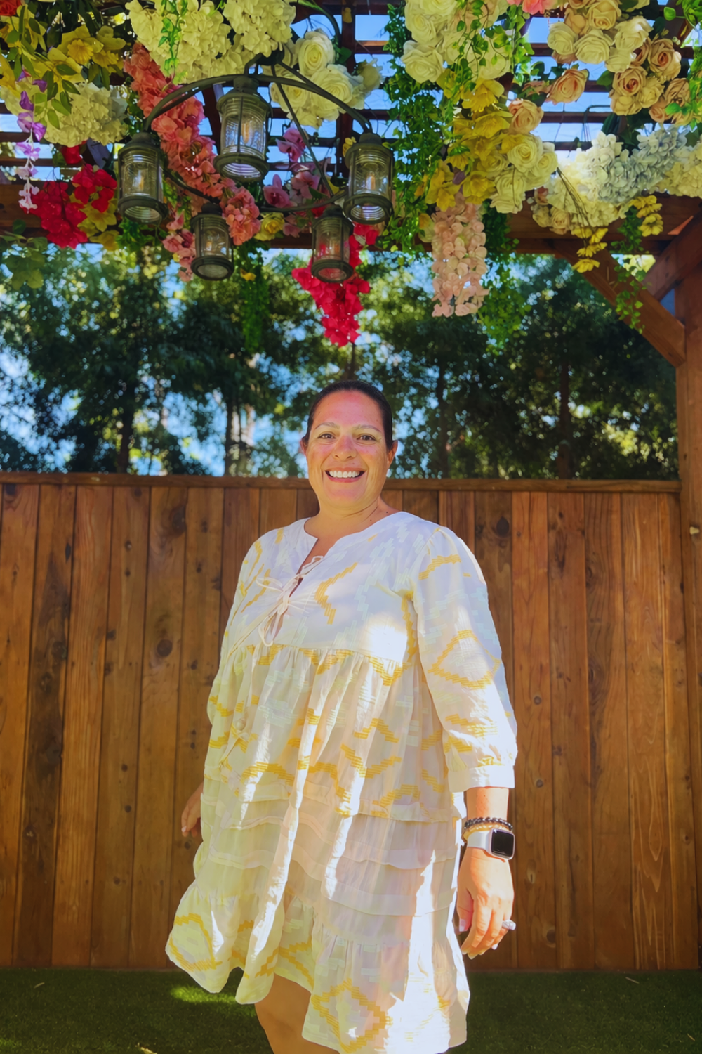 woman smiling under flowers reflecting on life timeline and personal growth