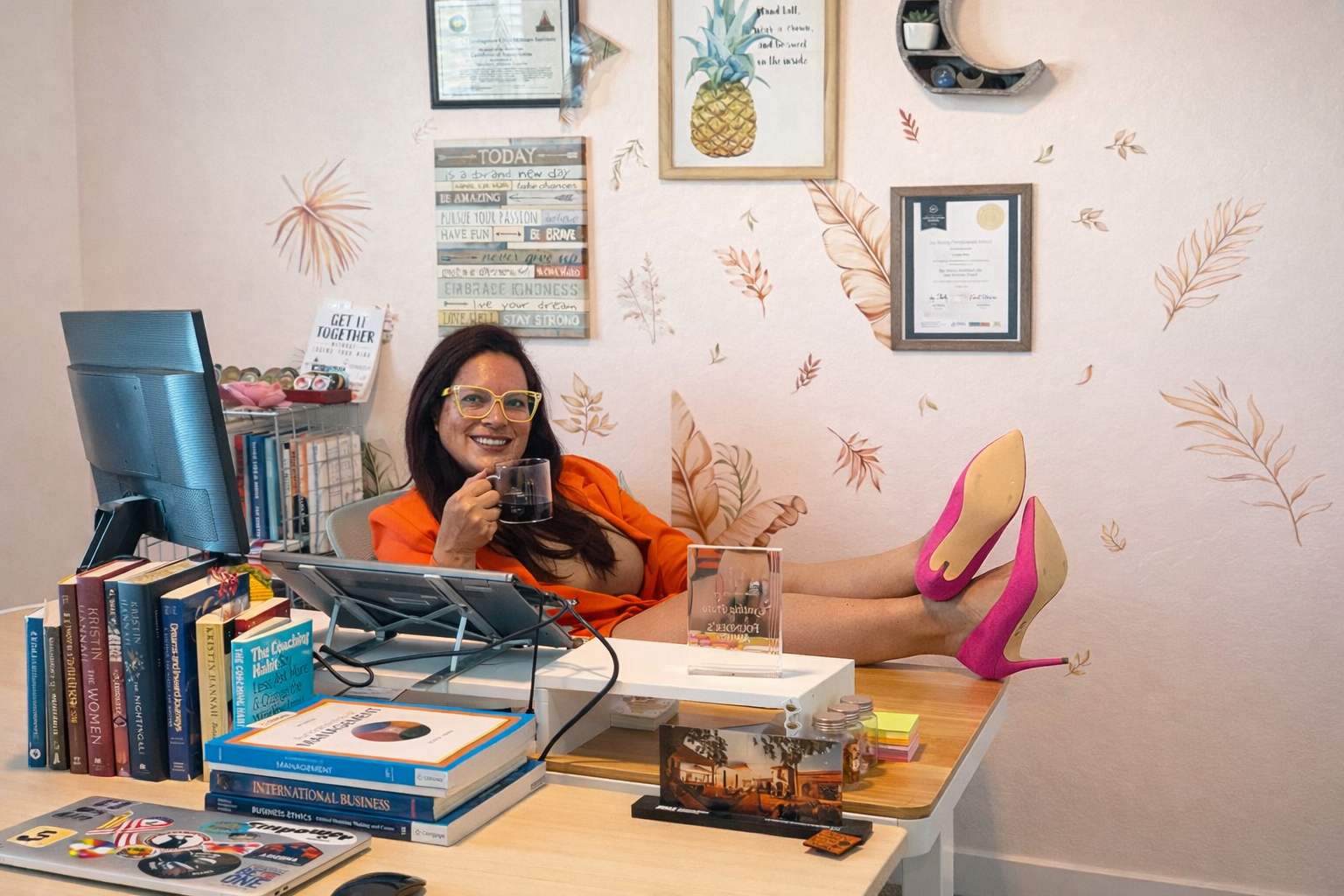 Professional woman relaxing at her desk representing high performers who experience pressure and comparison while pursuing success.