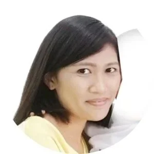 A woman with shoulder-length black hair smiling at the camera.