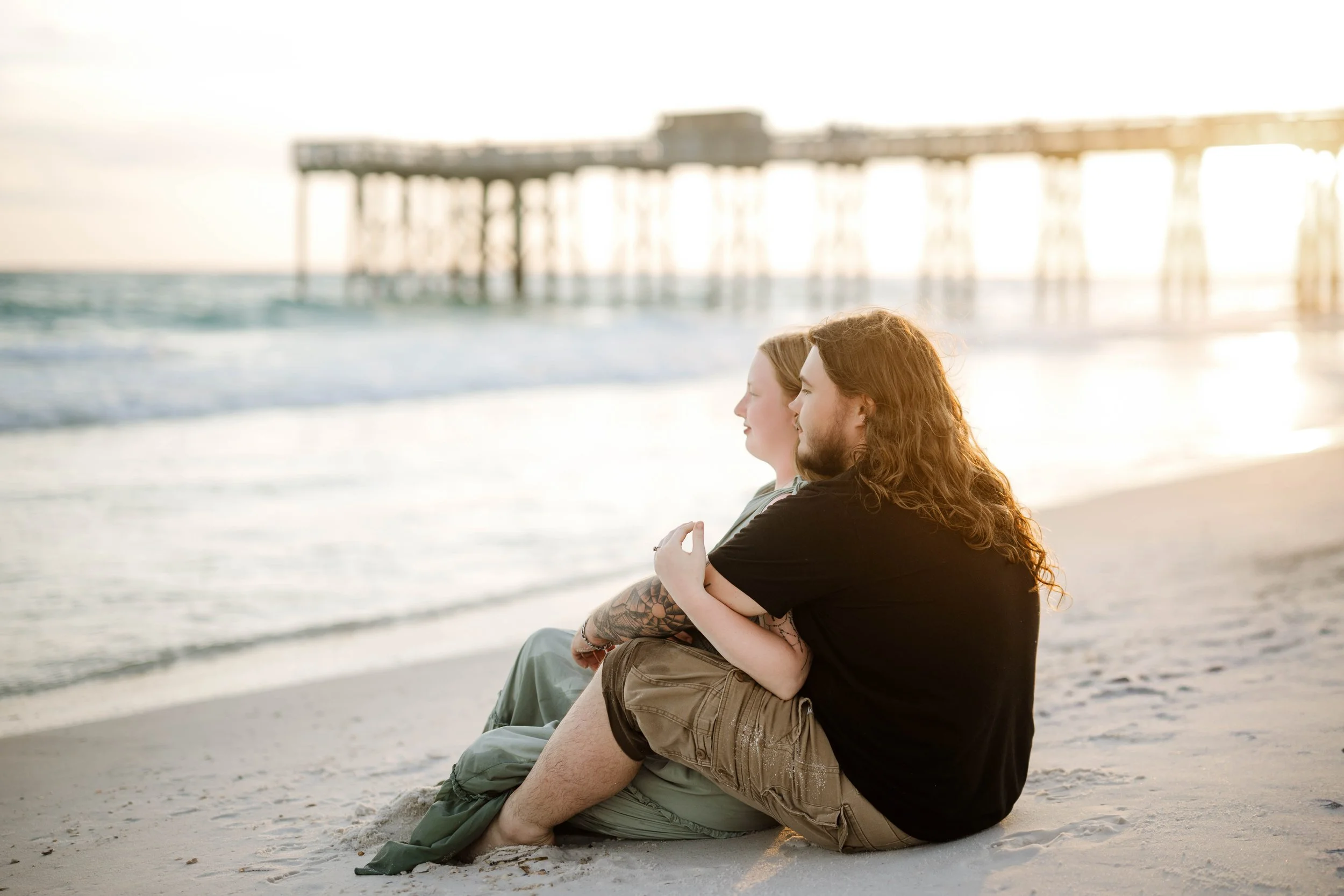 couple on the beach at sunset at st andrews state park in Panama City beach doing a photoshoot