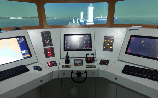 Navigation bridge of a ship with multiple control panels, screens, and a view of lighthouse and sea outside window.
