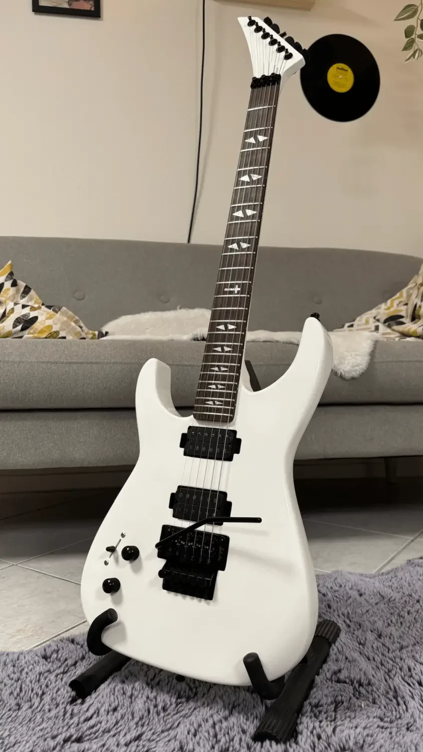 Eine weiße linkshänder E-Gitarre mit schwarzer Hardware