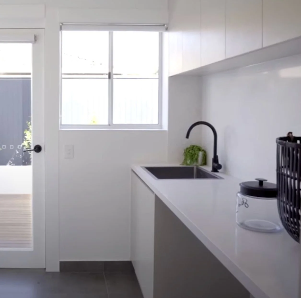 Keilor East laundry renovation with smart storage and stone bench