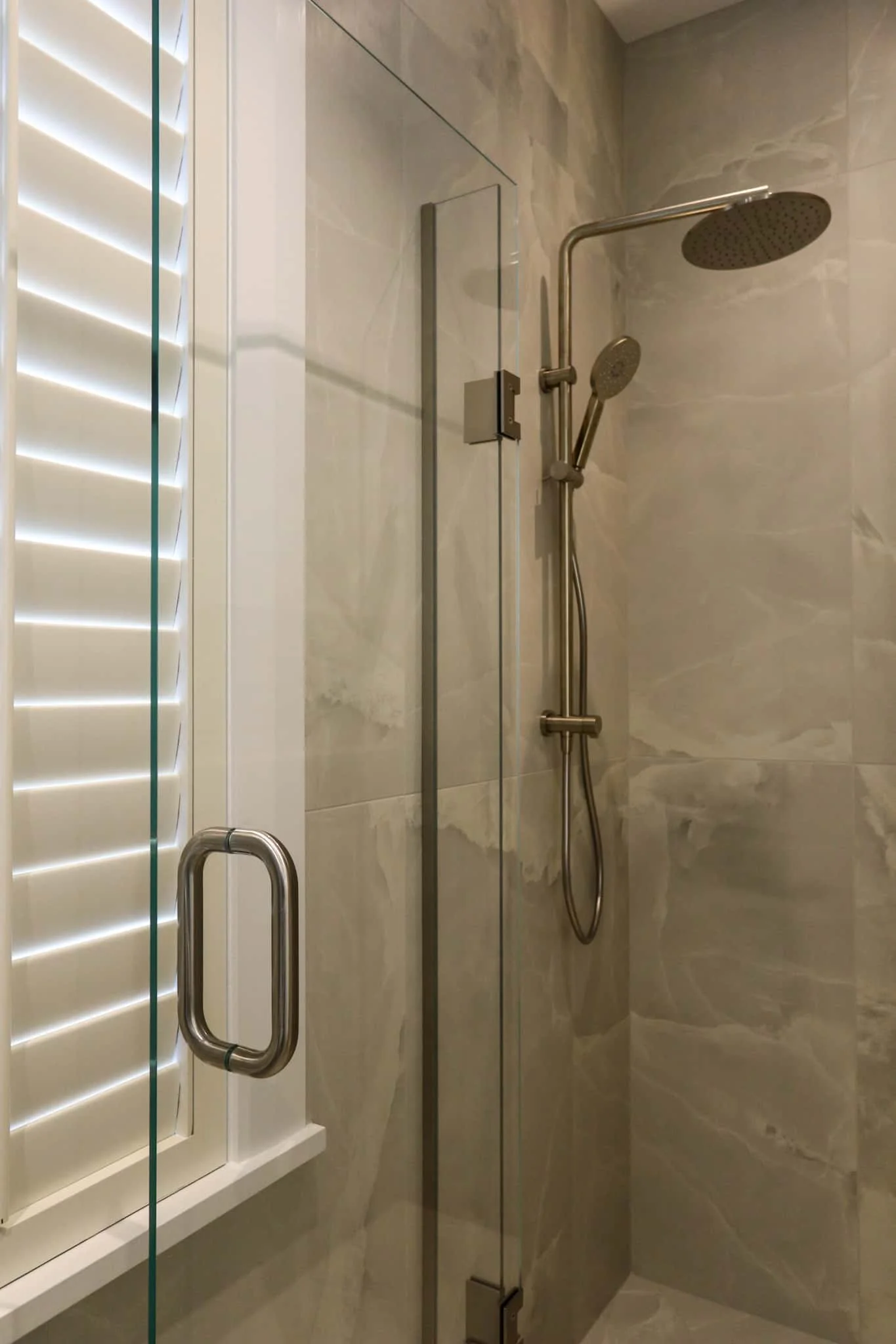 Shower with wall-mounted brushed nickel tapware in a Strathmore renovation