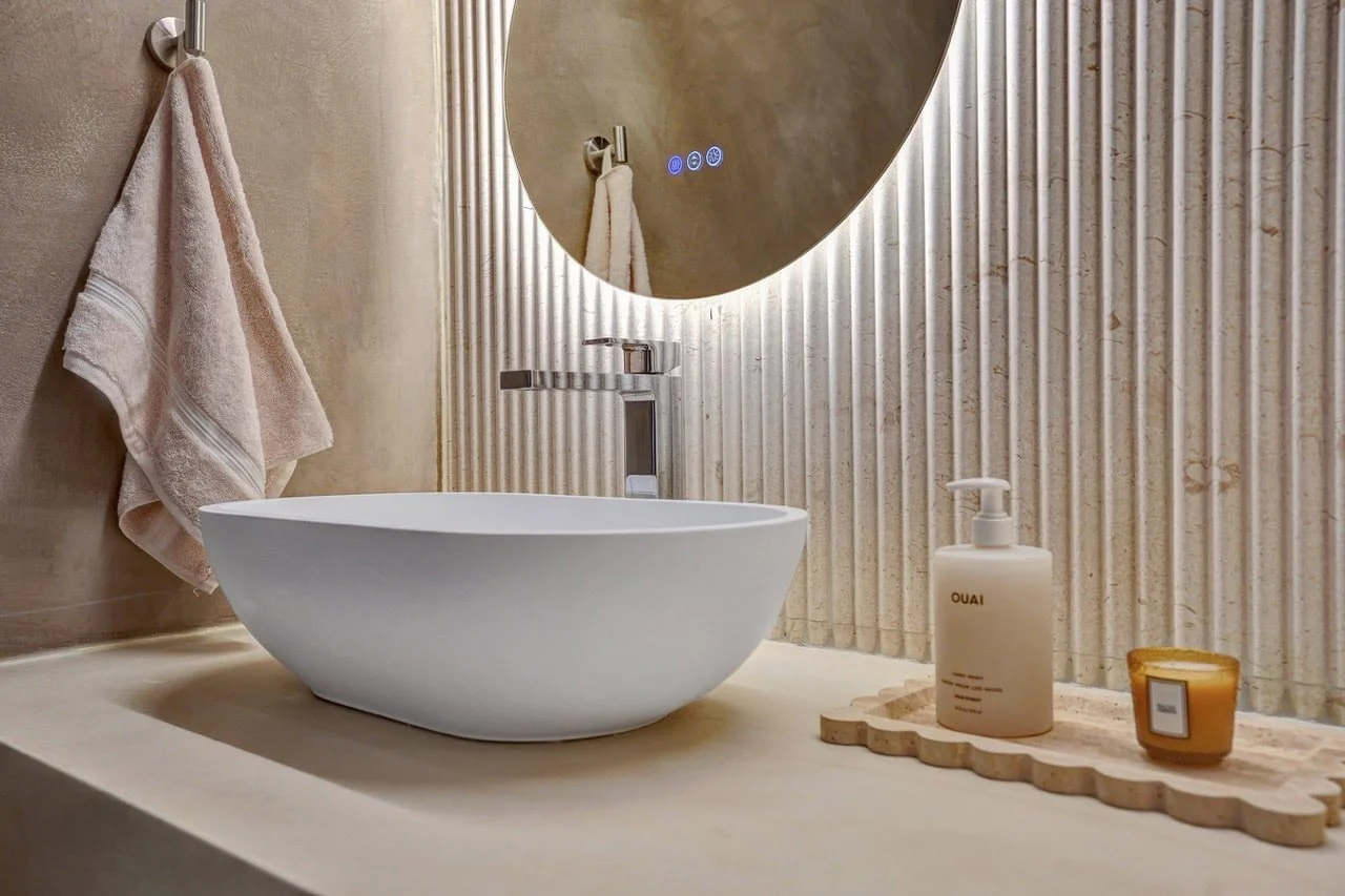Custom concrete vanity benchtop with a white ceramic vessel basin in an Essendon bathroom renovation