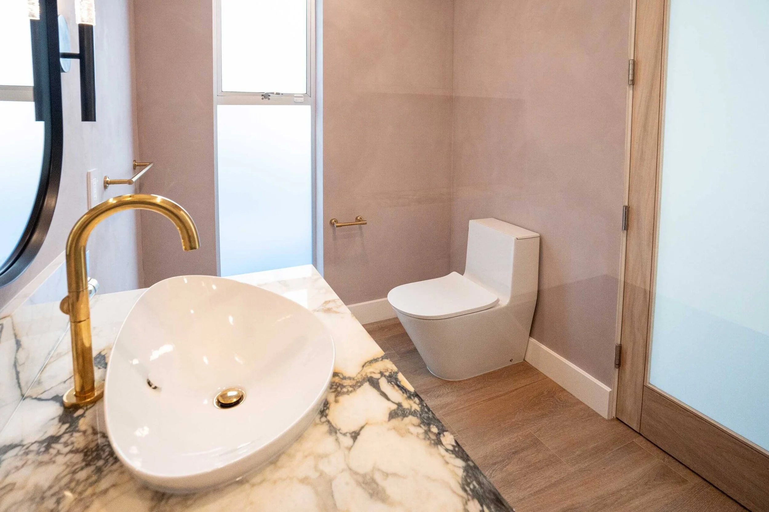 Sussex brushed gold tapware and pink tone wall in Toorak bathroom renovation