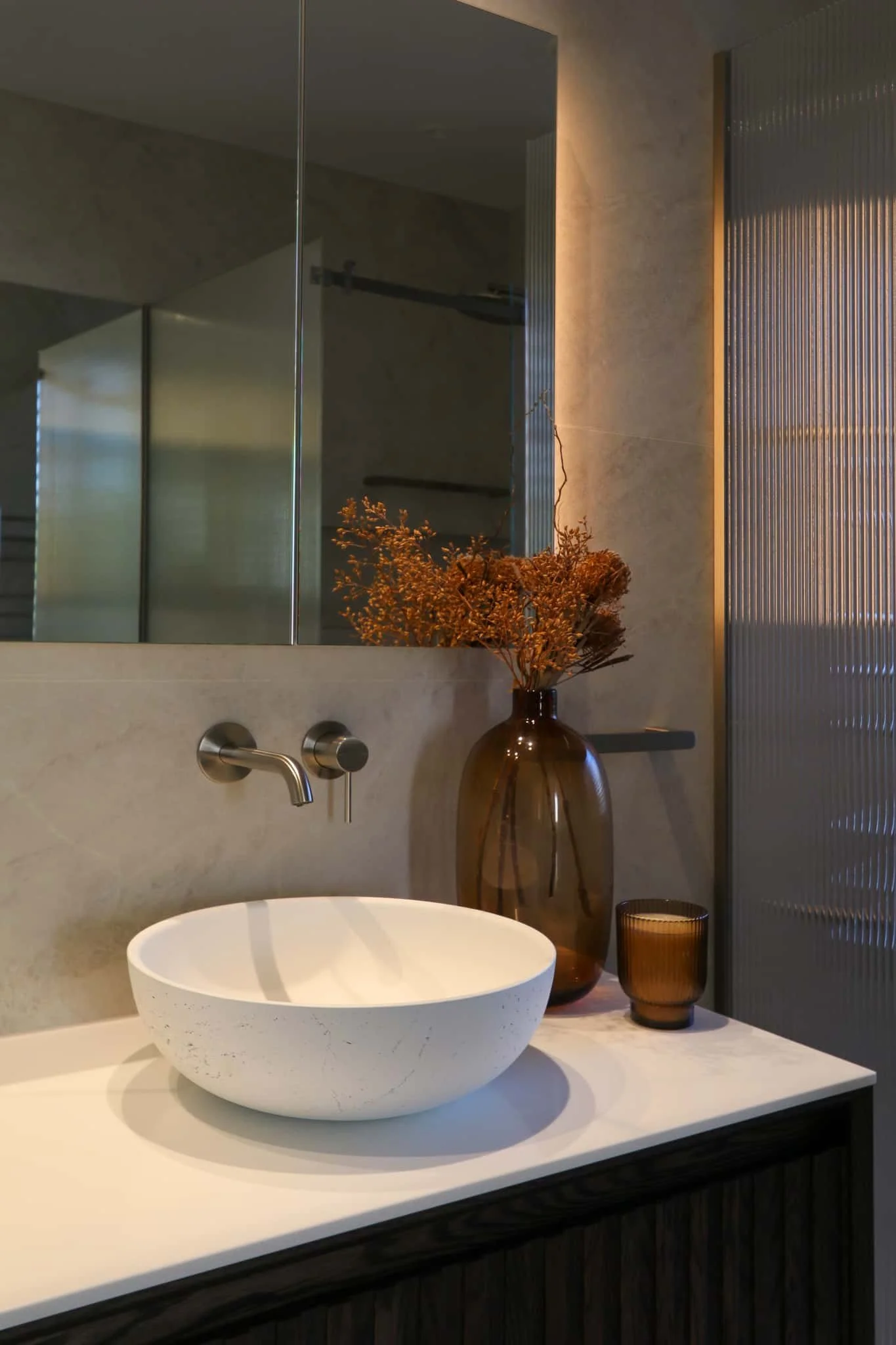 Dark timber vanity with white concrete basin and brushed nickel fixtures in Strathmore